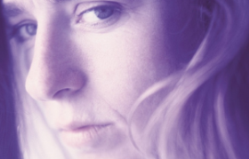 Close up image of a woman's face wearing an expression of sadness.